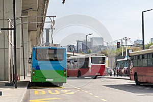 Electric bus at a stop is charged by pantograph. Clean mobility