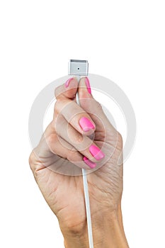 Electric cable with gadget connector in graceful female hand with beautiful manicure isolated on white background. Close