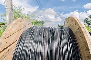 electric cable roll black wire and blue sky