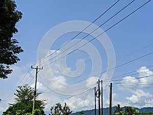electric cables and electric poles with clear sky view