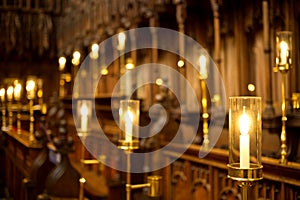 Electric candles in choir stalls, Ripon cathedral. Bokeh background.
