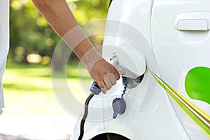 Electric car battery charging at charge station in the nature