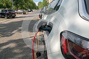 Electric car: being recharged, connected with the red cable to the electrical control unit