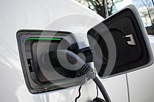 Electric Car Charger At Home plugged in and Charging EV with lights on