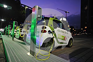 Electric cars powering at charging station