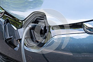 An electric car on the charging cable