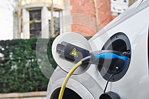 Electric Car Charging. Charger connector plugged to Electric auto