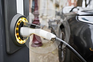 Electric Car Charging. Charger connector plugged to Electric auto