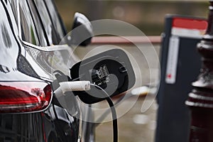 Electric Car Charging. Charger connector plugged to Electric auto