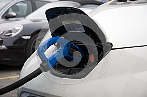 Electric car is charging at a special charging station