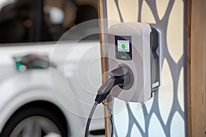 Electric car (EV) is charging in socket with cable