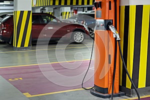 Electric car fast charging station at indoor underground parking. Power supply point network for hybrid electric car charging