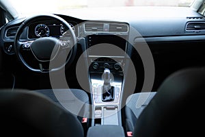 Electric car interior details adjustments. Inside car interior with front seats, driver and passenger, textile, windows