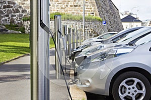 Electric car plugged in to electricity