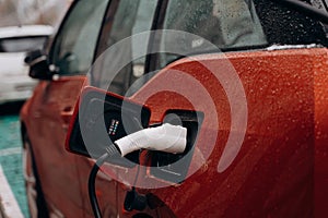 Electric car with power cable supply plugged in