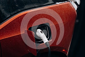 Electric car with power cable supply plugged in