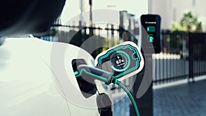Electric car recharge to charging station at car park display hologram. Peruse
