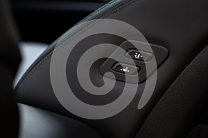 Electric car seat adjustment control panel close up view.