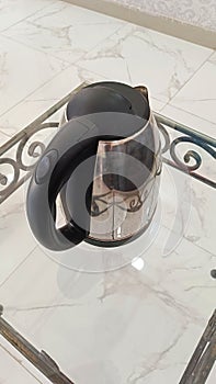 close up of electric cattle in mirror table