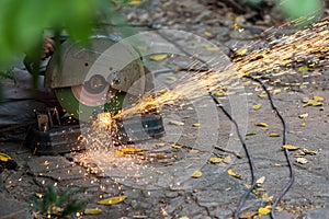 Electric circular steel cutting machine and sparkle.  workers use tools to cut steel for building up and sparks from real-world si