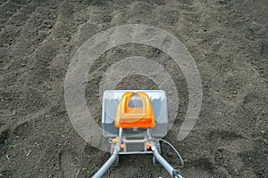 Electric cultivator cultivates soil in vegetable garden