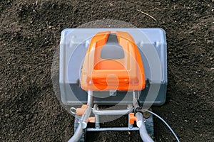 Electric cultivator on soil in vegetable garden