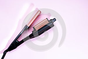 Electric Curling cast iron with ceramic plates isolated on a pink background. The view from the top