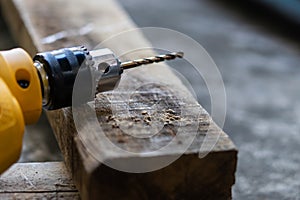 Electric driller and wood for carpenter`s job