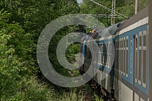 Electric engine and blue coach from window