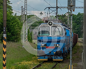 Electric engine and blue coach from window