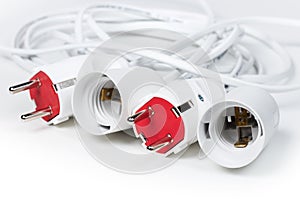 Electric European plug and lamp holder. White power cable with plug. Power cord close-up