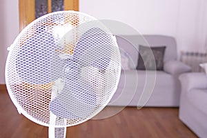 Electric fan that cools the air during a hot day at home