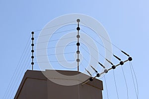 Electric Fence Against Blue Sky Atop Boundary Wall