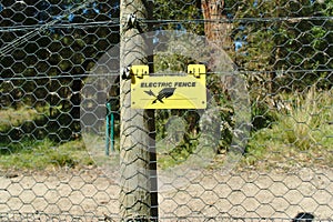 Electric fence sign in yellow color