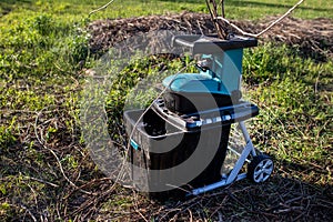 electric garden grinder to shred with a extended filled tank for crushed branches, ready for use in solid fuel boilers