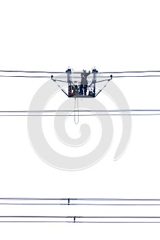 Electric gondola with man at work on high tension power cables
