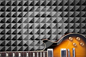 Electric guitar on acoustic foam panel background