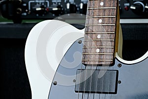 Electric guitar on the background of the guitar amplifier.