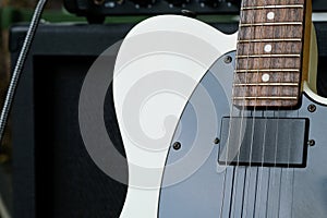 Electric guitar on the background of the guitar amplifier.