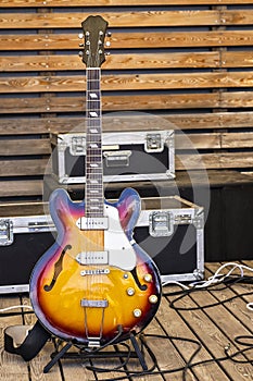 Electric guitar on the background of a wooden wall