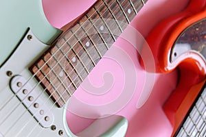 Electric guitar and bass guitar on a pink background