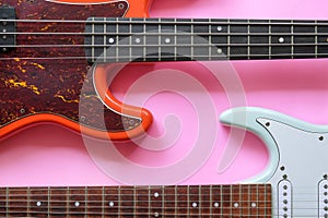 Electric guitar and bass guitar on a pink background