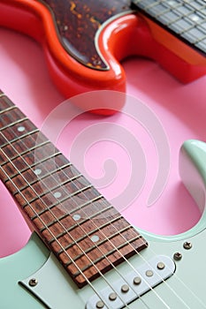 Electric guitar and bass guitar on a pink background