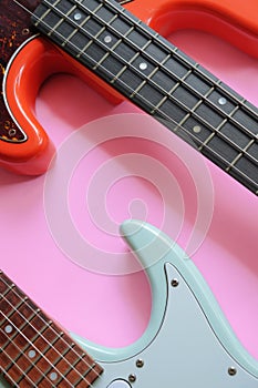 Electric guitar and bass guitar on a pink background