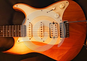 An electric guitar bathed in warm light