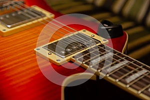 Electric guitar body and neck detail on wooden background vintage look