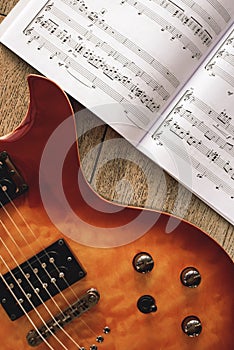 Electric Guitar Chords. Close-up photo of electric guitar body with volume and tone control knobs with music notes