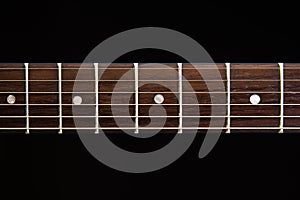 Electric guitar fingerboard, black background photo