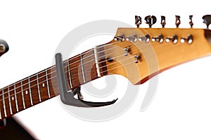 Electric guitar fretboard with capodaster, closeup