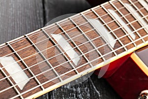 electric guitar fretboard on wood